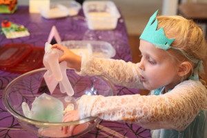 Picture of child playing with a Halloween hand - latex filled with water and glitter glue