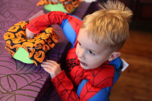 Picture of child reaching into a Halloween sensory container