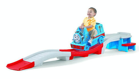 kid riding a toy Thomas the Train roller coaster