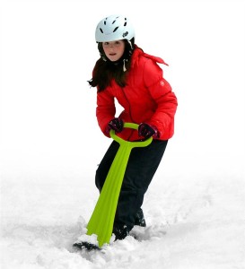 picture of a kid riding a snow scooter
